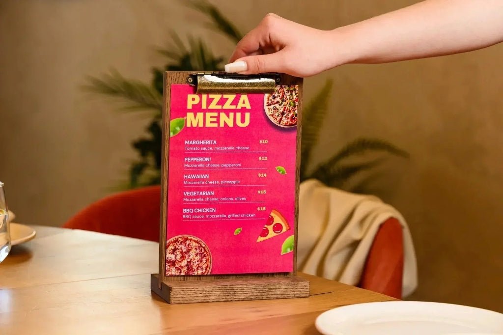 Wooden menu holder stand with brass clip on a restaurant table