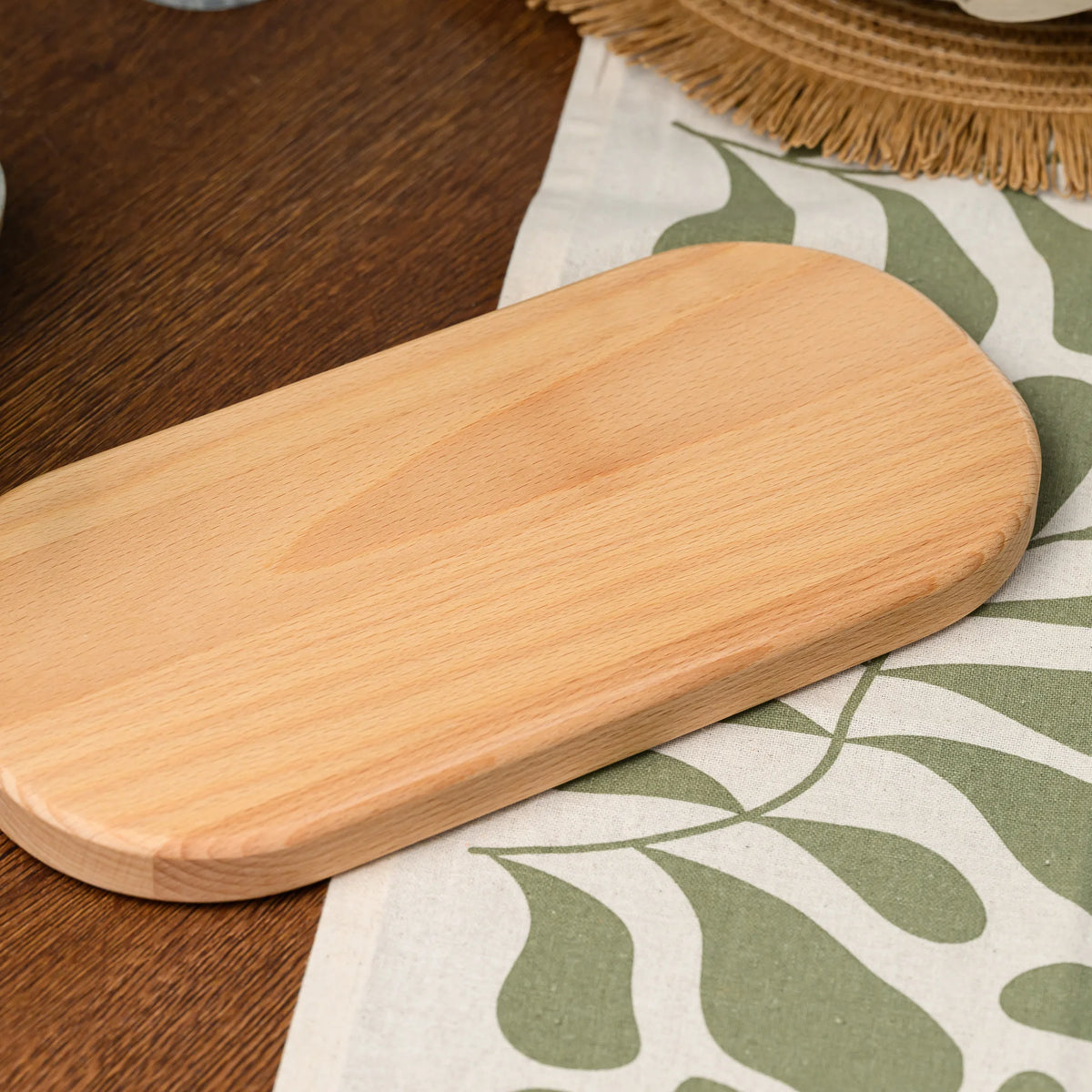 Close-up of the rounded end and smooth sealed surface of the beech wood rectangular serving board