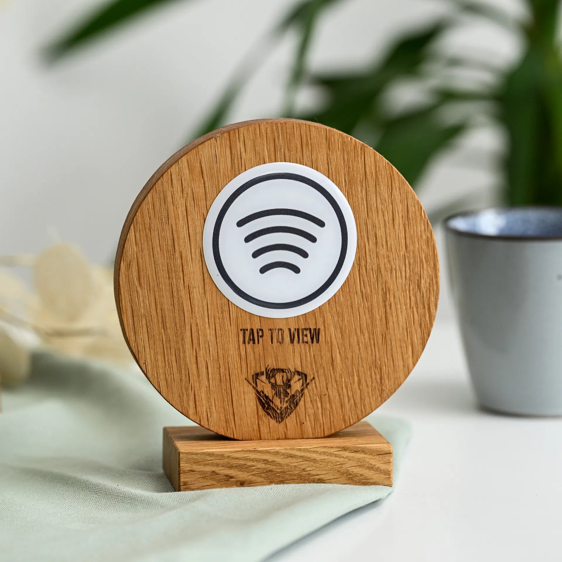 Elegant NFC tag sign atop a sturdy oak stand for seamless interaction.