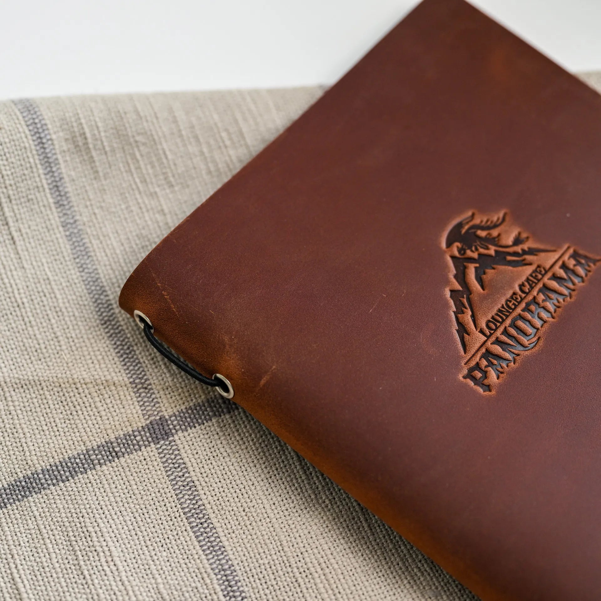 Impress guests with our personalized leather menu cover, featuring an elegant design and secure elastic band.