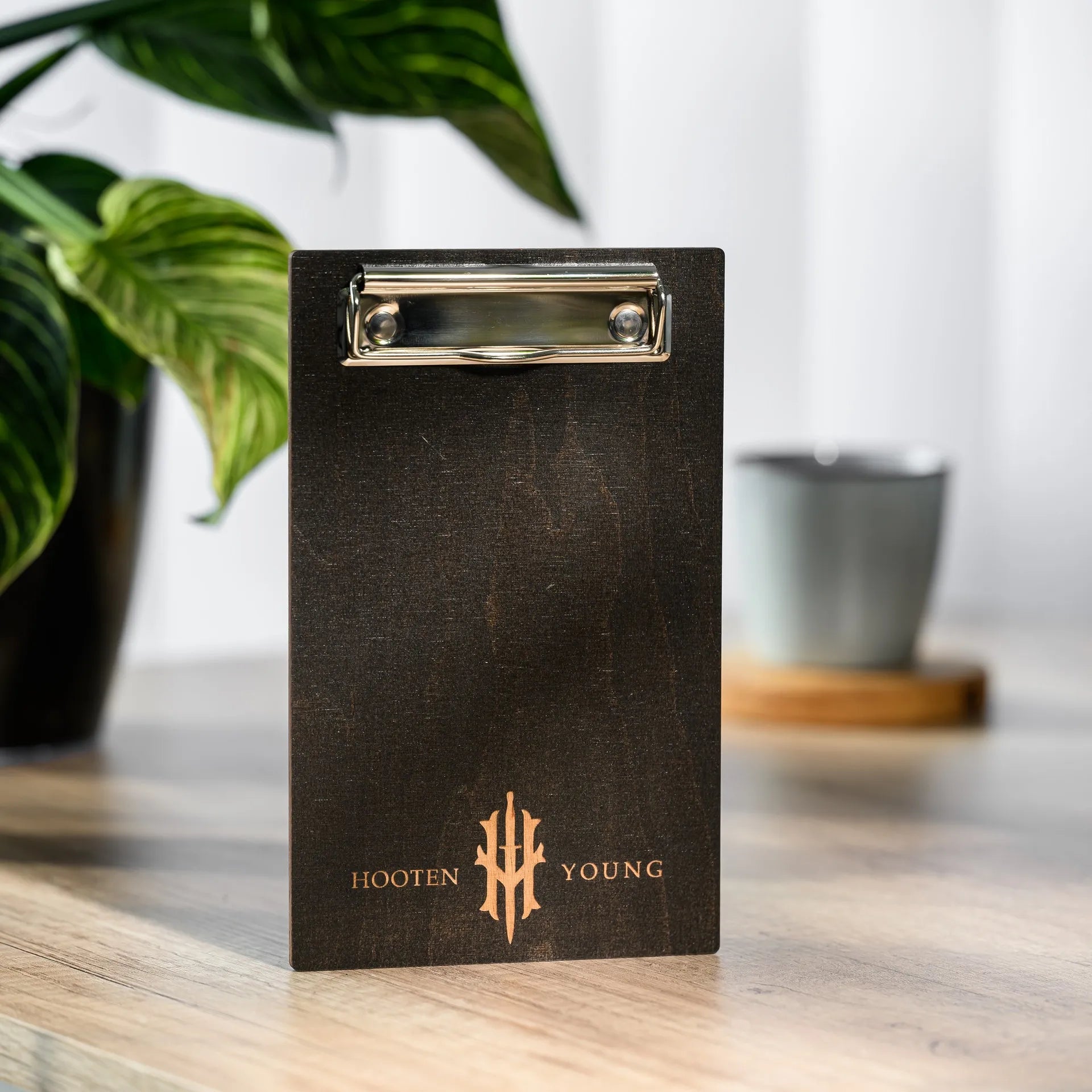 Wooden bill holder with metal binder, ideal for restaurants, combining durability with a modern design for elegant bill presentation.