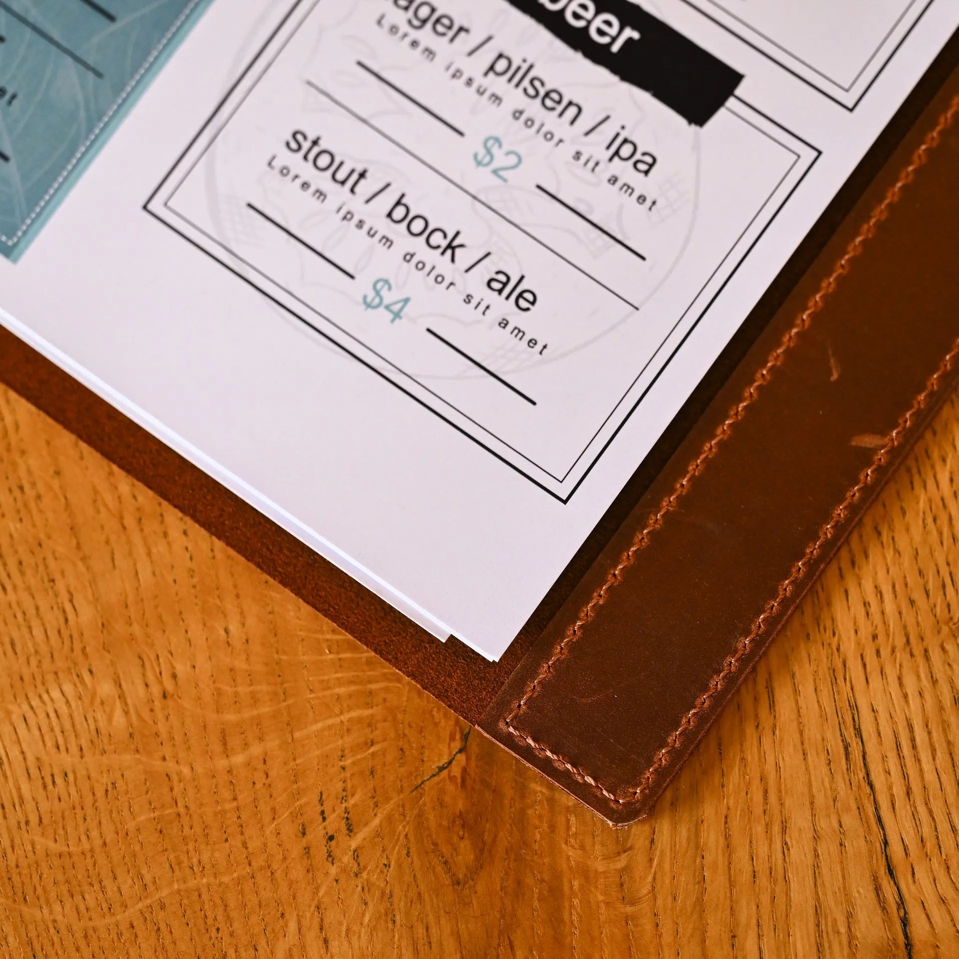 Customizable leather menu holder with a ring binder, ideal for holding Letter and A4 sheets. Perfect for restaurants looking for stylish presentation.