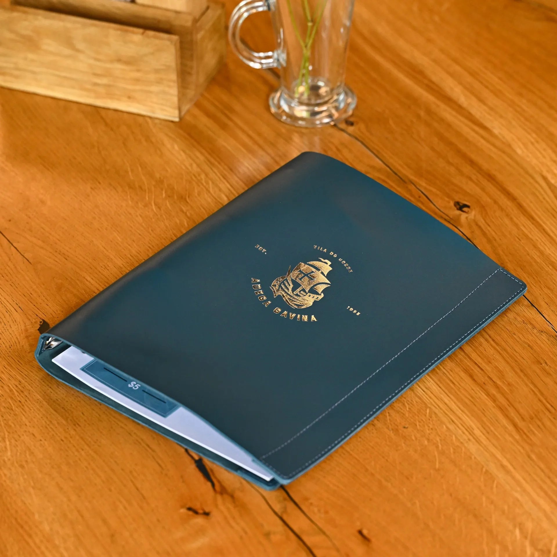 Customizable menu folio with logo, designed for restaurants. Sleek cover with a ring binder for organizing menu pages in US Letter or A4 formats.