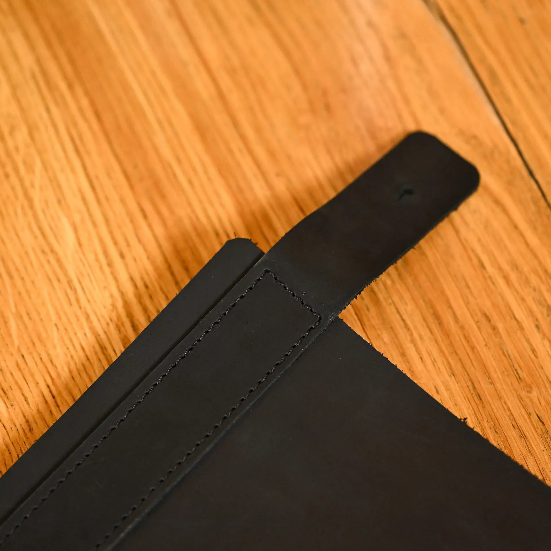 Soft leather menu holder with rubber strip binding, customized with embossed logo. Ideal for securely holding half A3 menus with a polished finish.