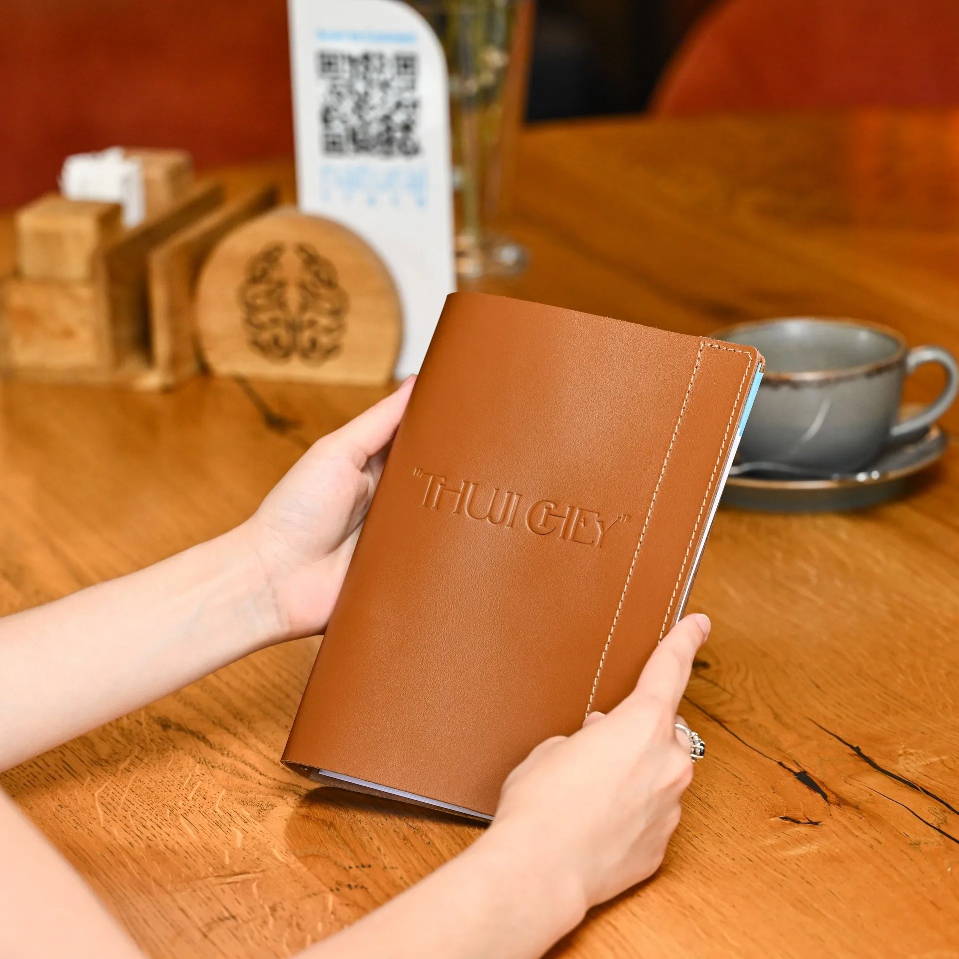 Leather menu cover with a fixing plank for securing sheets. Customizable design, ideal for holding A5-sized restaurant menus