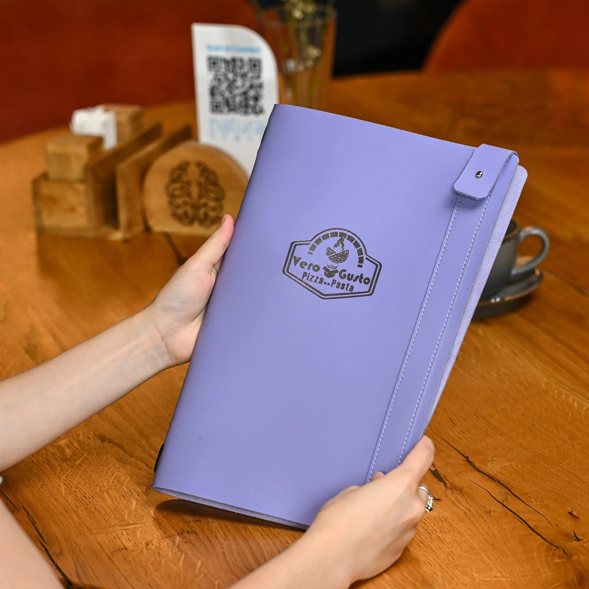 Soft leather menu folder for half sheets with elastic strap binding and custom logo, perfect for easily changing drink or menu pages.