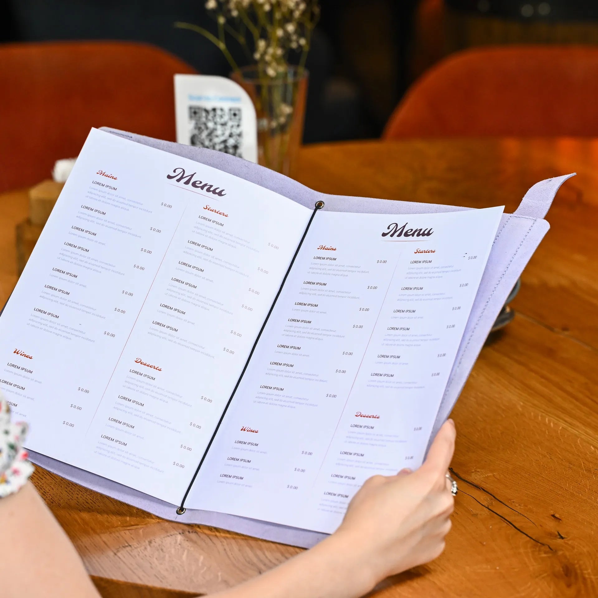 Elegant leather menu holder with elastic strap for half sheets, featuring a customizable embossed logo and quick-change options for drink menus.