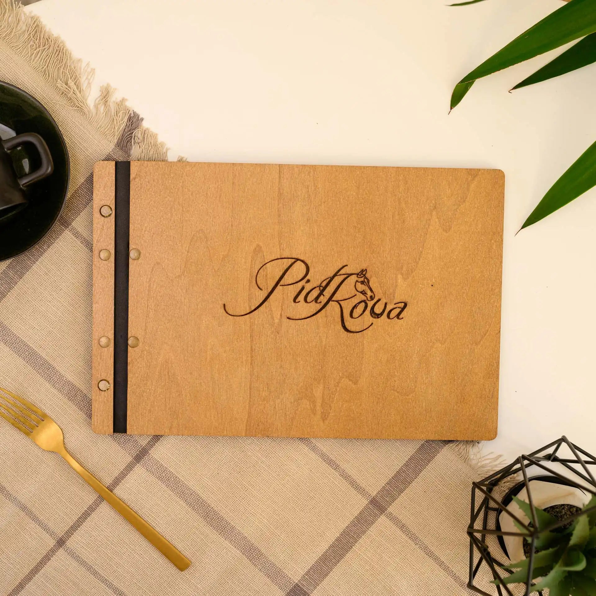 Landscape Menu Folder: Stylish and secure with a leather strap fastening.