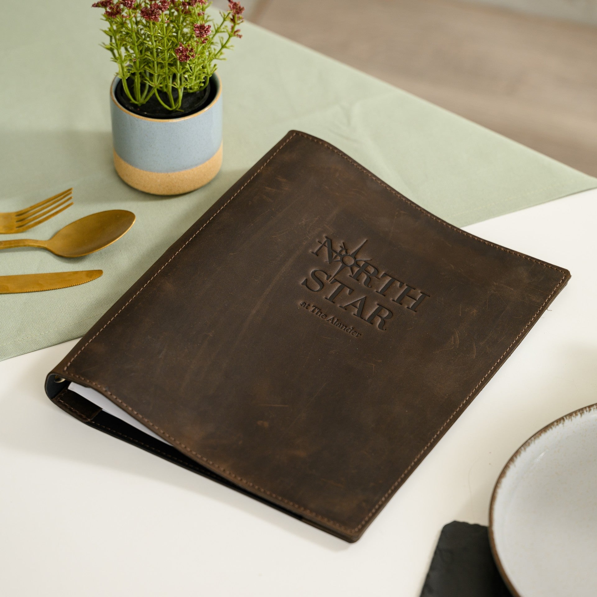 Our leather menu holder with binder offers a sleek solution for showcasing your offerings.