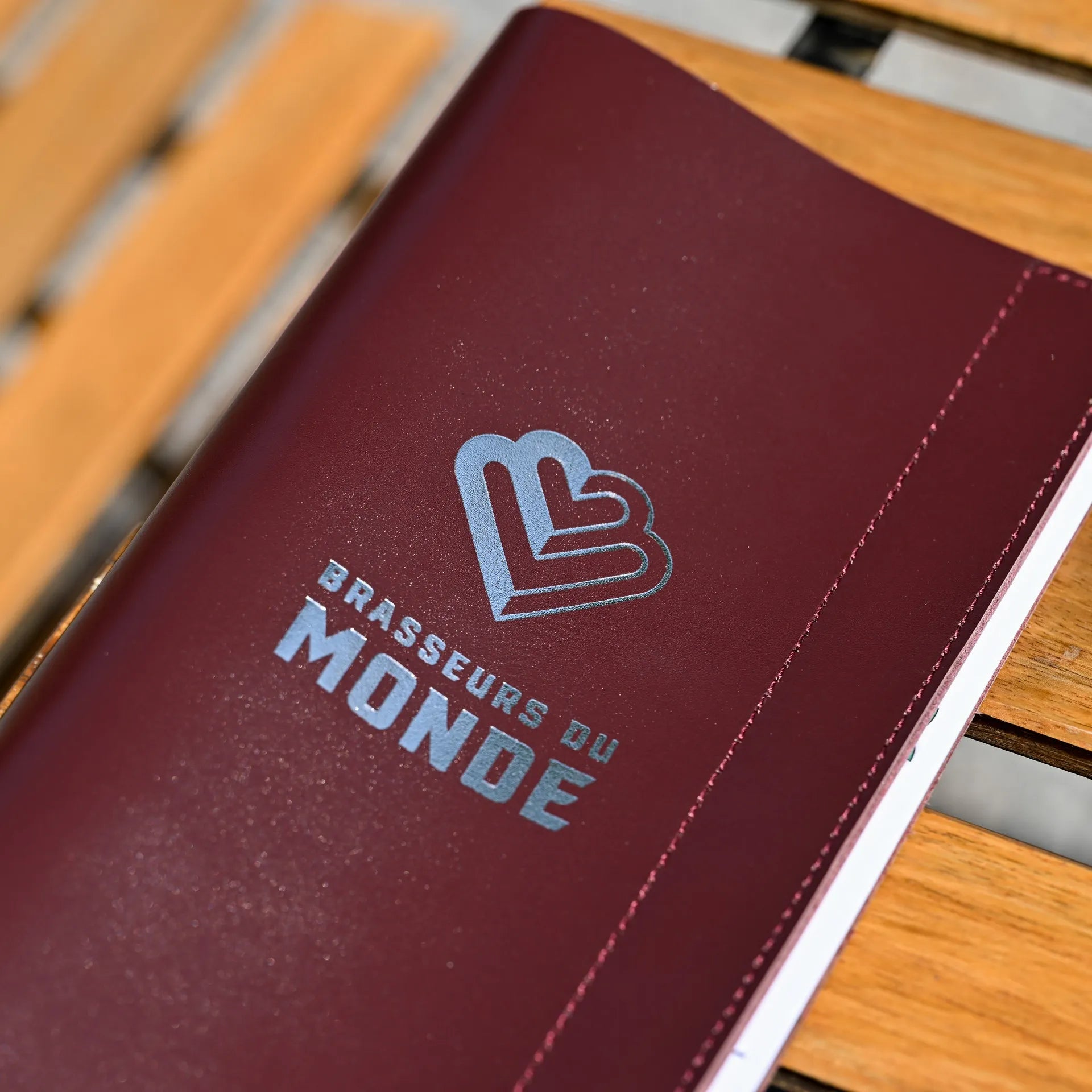 Sophisticated leather drink menu holder with a ring binder mechanism. Customizable logo embossing, perfect for wine lists in fine dining settings.