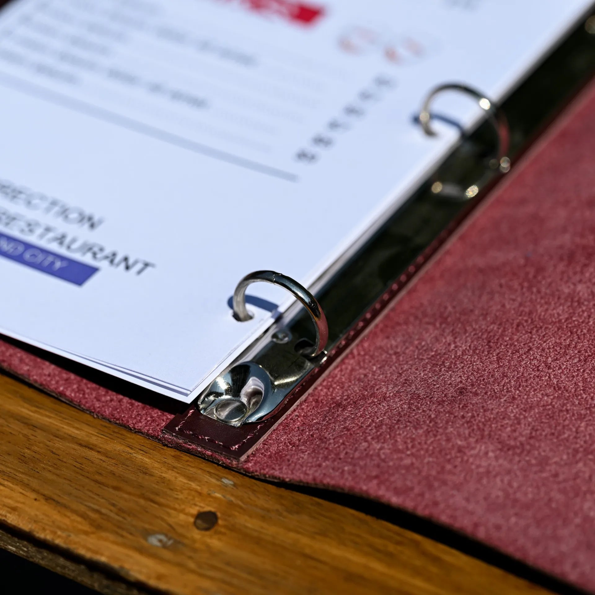 Leather wine list menu cover with a ring binder mechanism, offering easy sheet changes. Personalize with embossed logos for a professional touch.