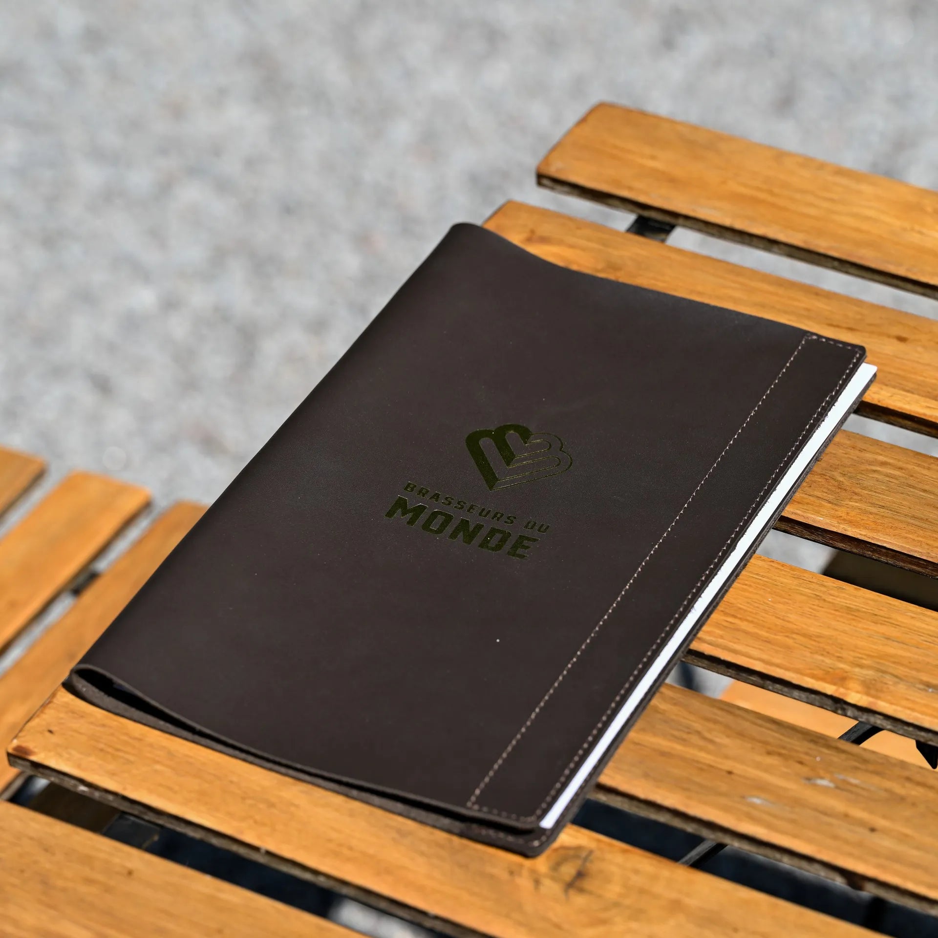 Premium leather menu cover with a fixing plank for wine lists, featuring embossed logo for a personalized and professional restaurant look.