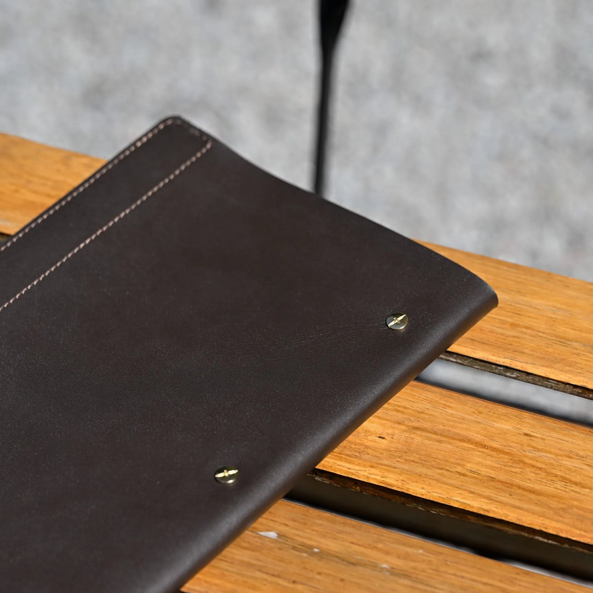 Custom leather menu cover for wine lists with a fixing plank mechanism, complete with embossed logo for a personalized, high-end presentation.