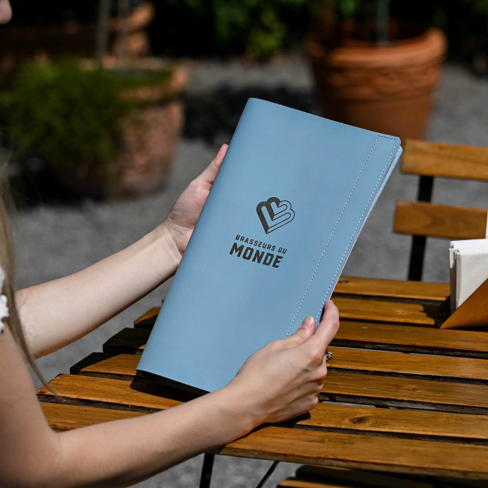 Leather drink menu cover with a ring binder mechanism and custom logo embossing, perfect for a sleek and personalized presentation of your menu.