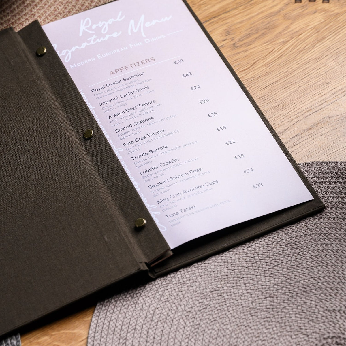 Wide open espresso-brown textile menu folder with a lavender page and V-notch binding on a wooden table