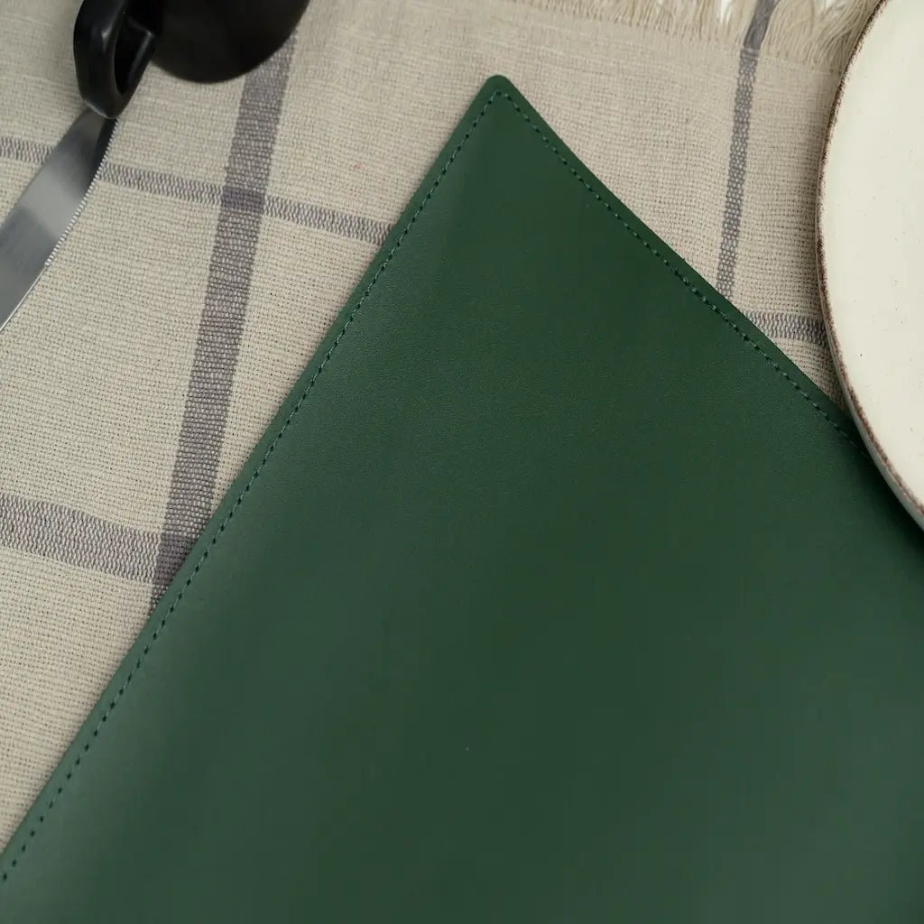 Close-up of a green leather surface with a checkered fabric background