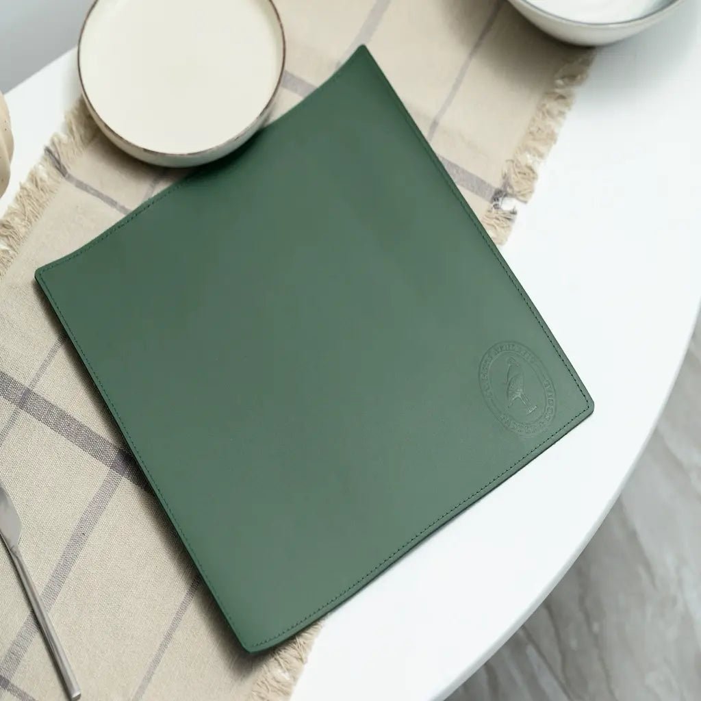 Green placemat on a white table with a checkered tablecloth