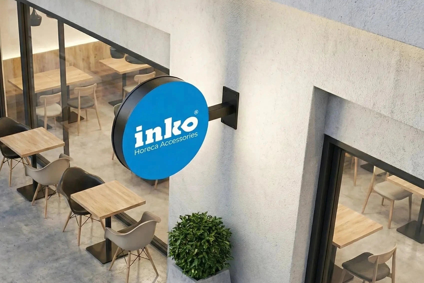 Inko store entrance with a blue sign and chairs outside