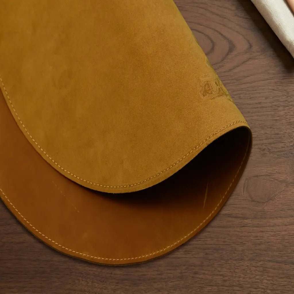Brown leather mat on a wooden surface