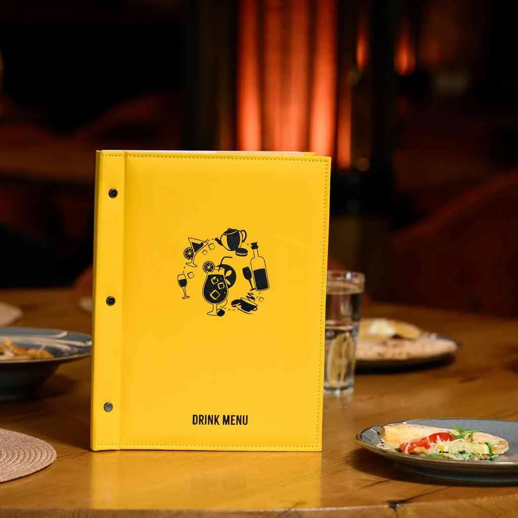 Black PU faux leather menu cover with DTF printed logo on restaurant table