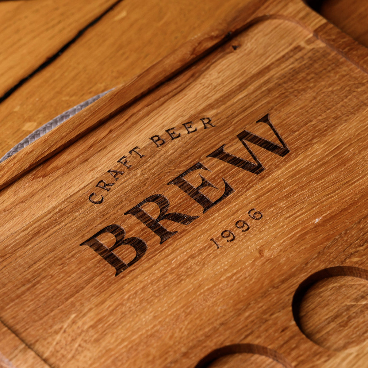 Oak beer flight board with full tasting set of spirit shots, sauce and mixed appetizers on rustic restaurant table