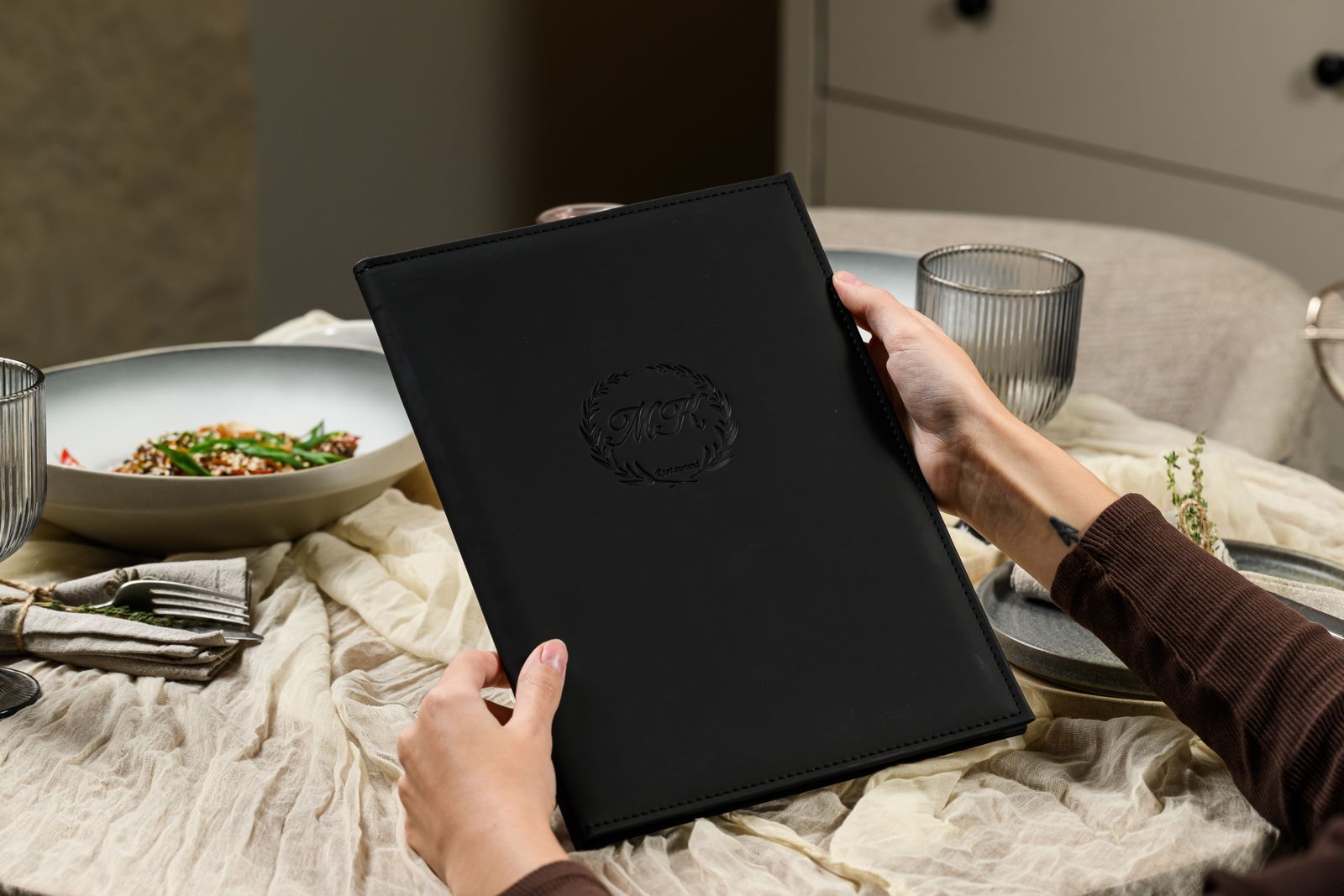 Black leather menu cover with embossed logo