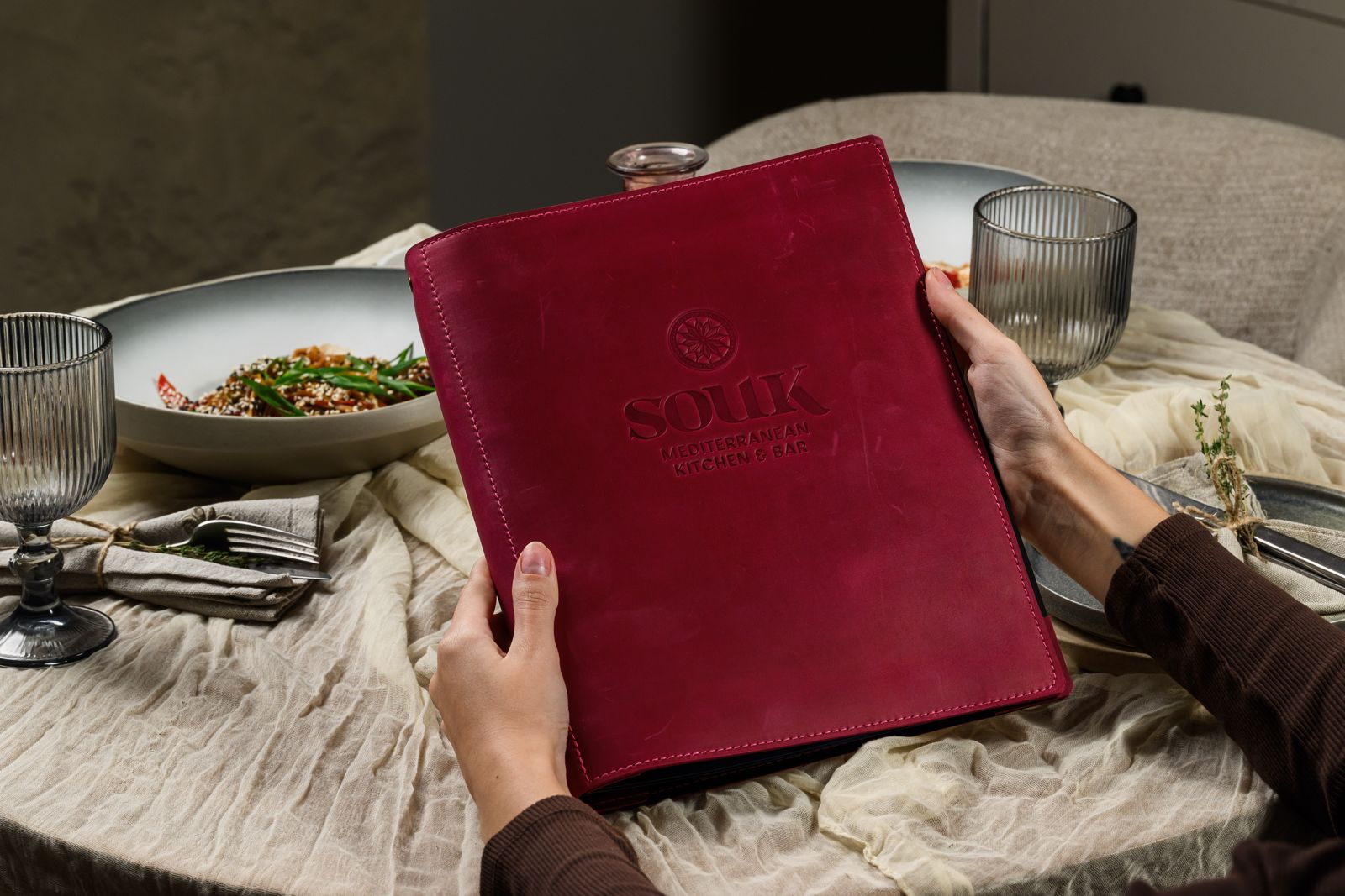Burgundy leather menu cover with embossed logo