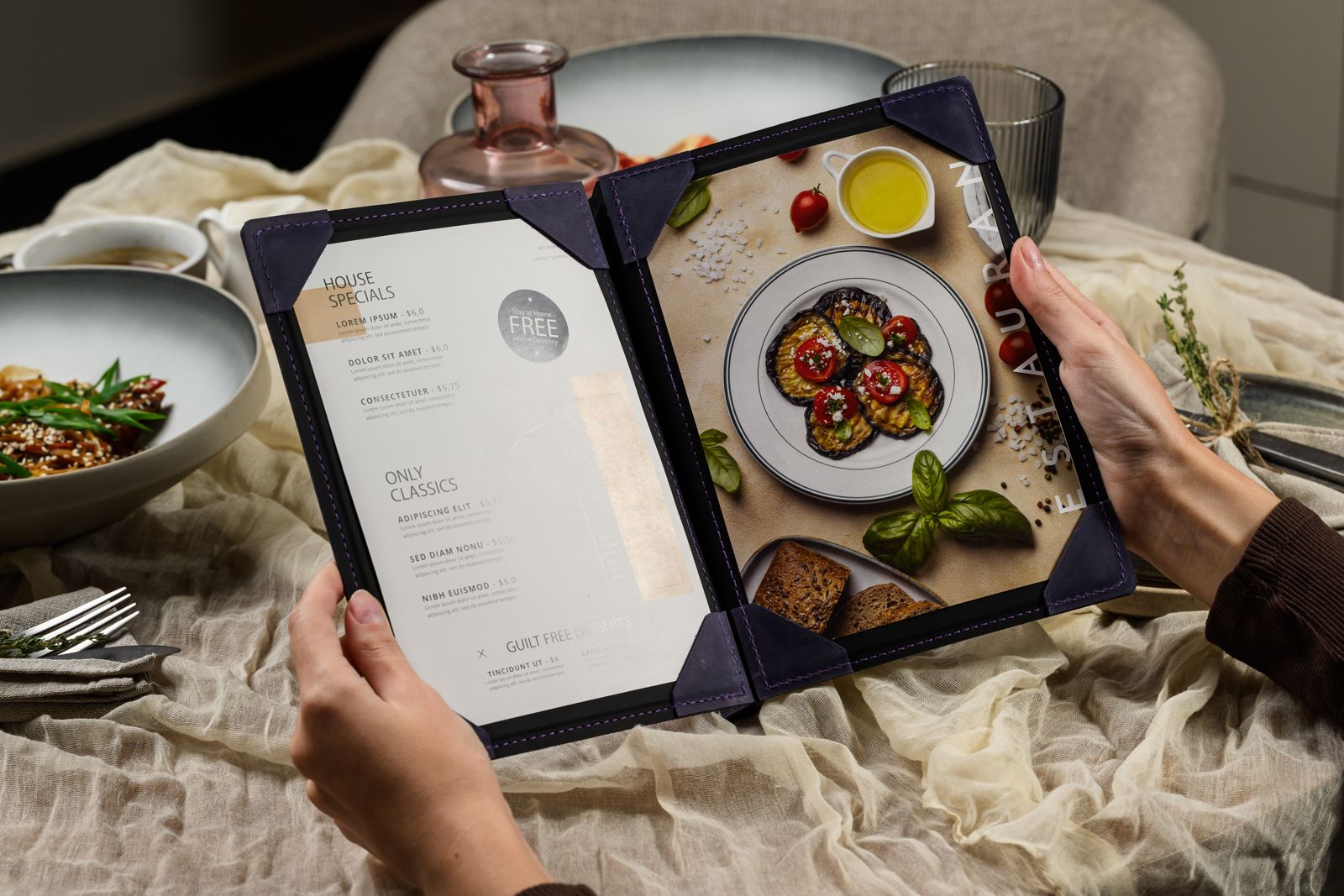 Guest holding an open navy menu folder with corner mountings