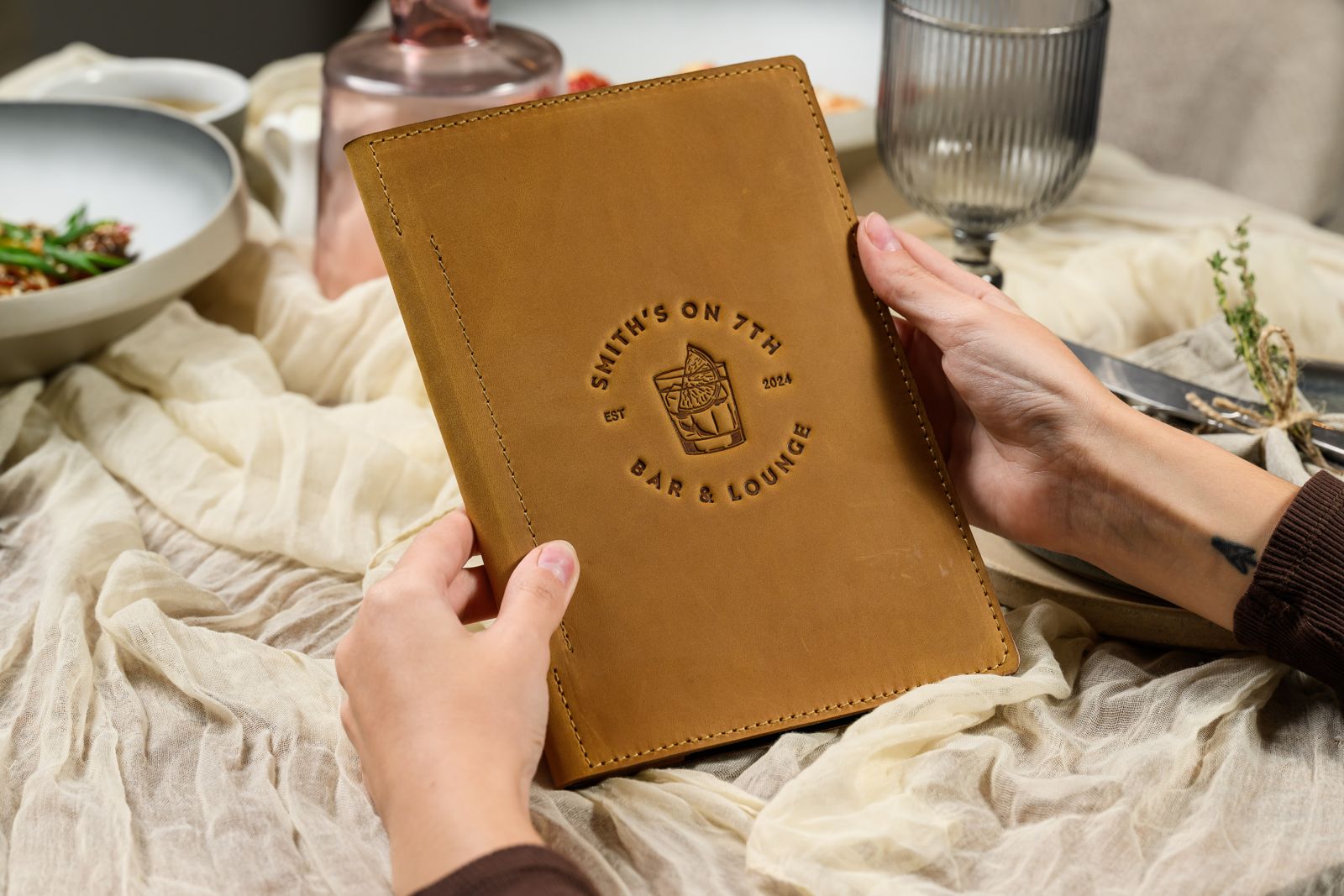 Ochre leather menu cover with embossed logo