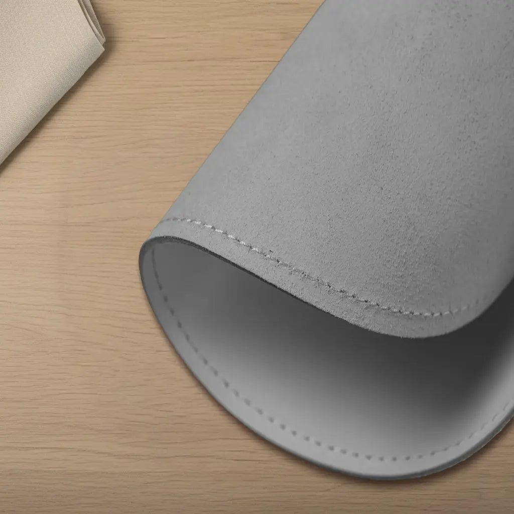 Gray leather sleeve on a wooden surface