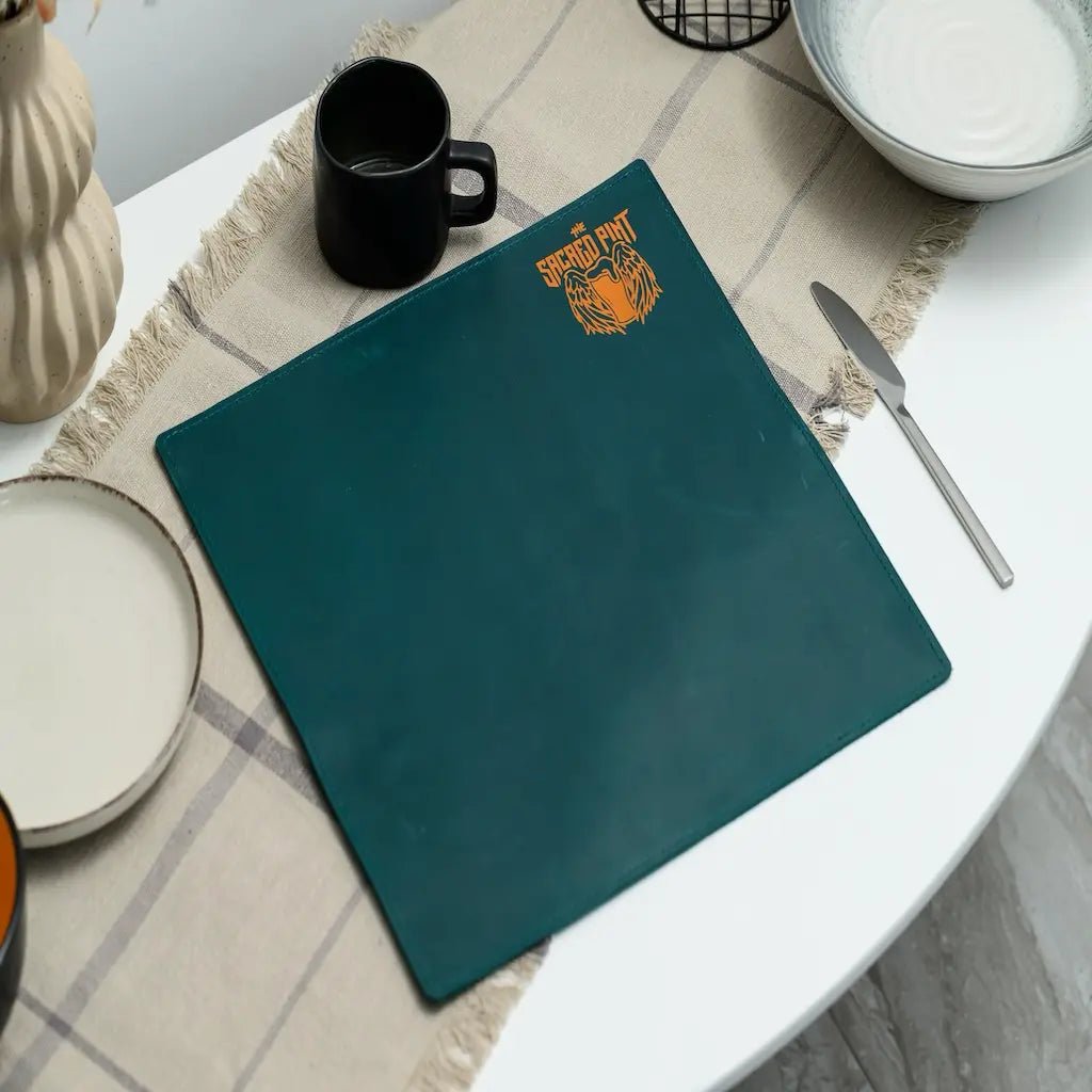 Teal placemat with a logo on a table setting