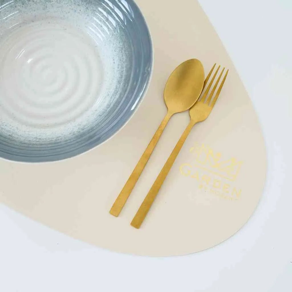Close-up of beige faux leather placemat with smooth, elegant texture